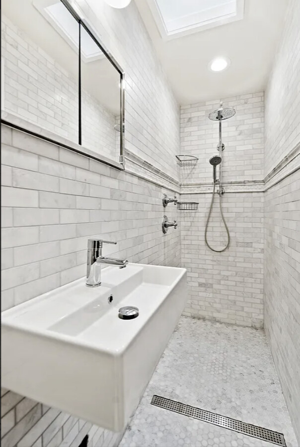 328 East 73rd Street, Unit 5B Manhattan, NY 10021 - Photo 8 of 10 a bathroom with a sink a toilet and shower