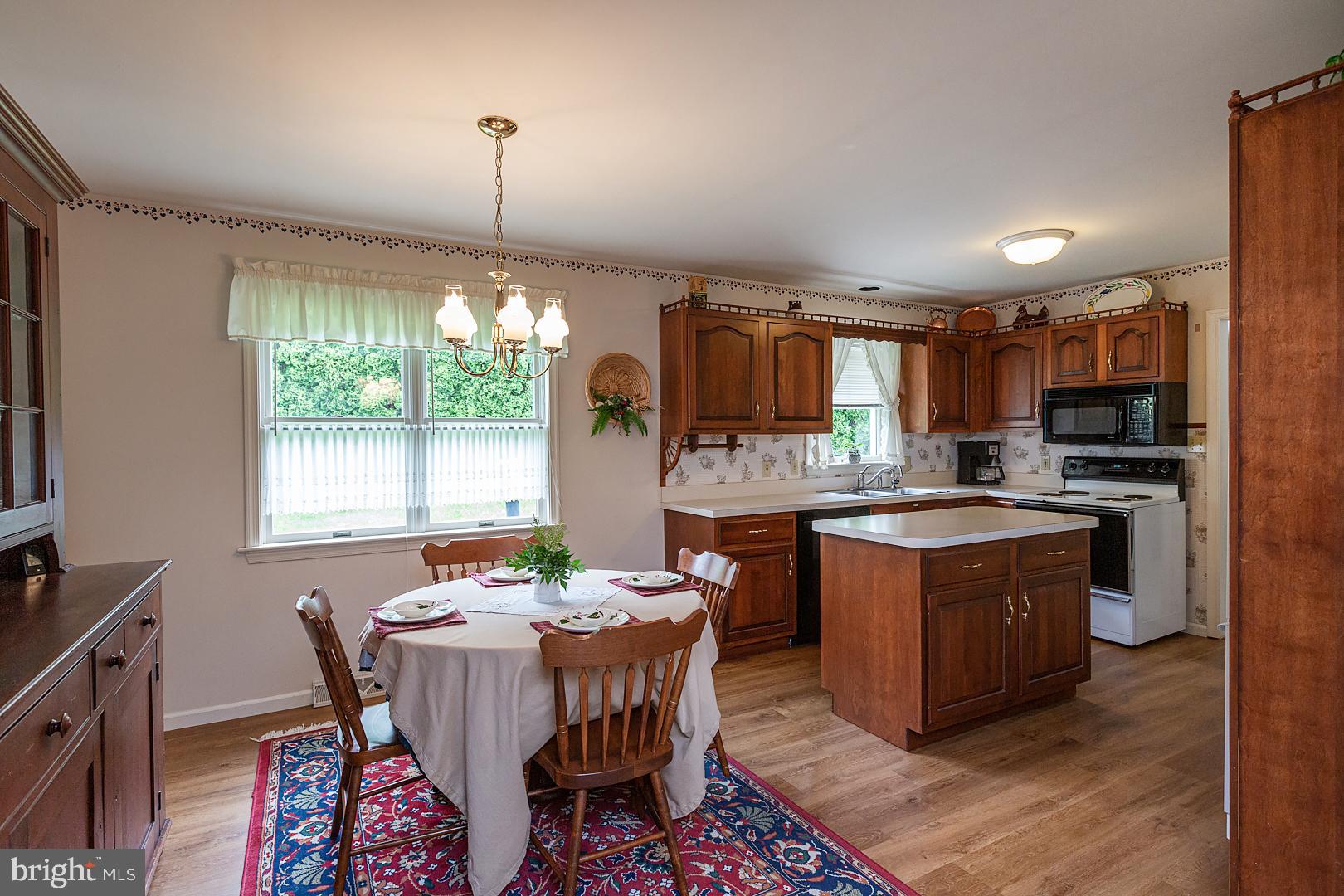 1 Hurst Boulevard Lititz, PA 17543 - Photo 18 of 62 a kitchen with stainless steel appliances granite countertop wooden floors a stove a sink and a window