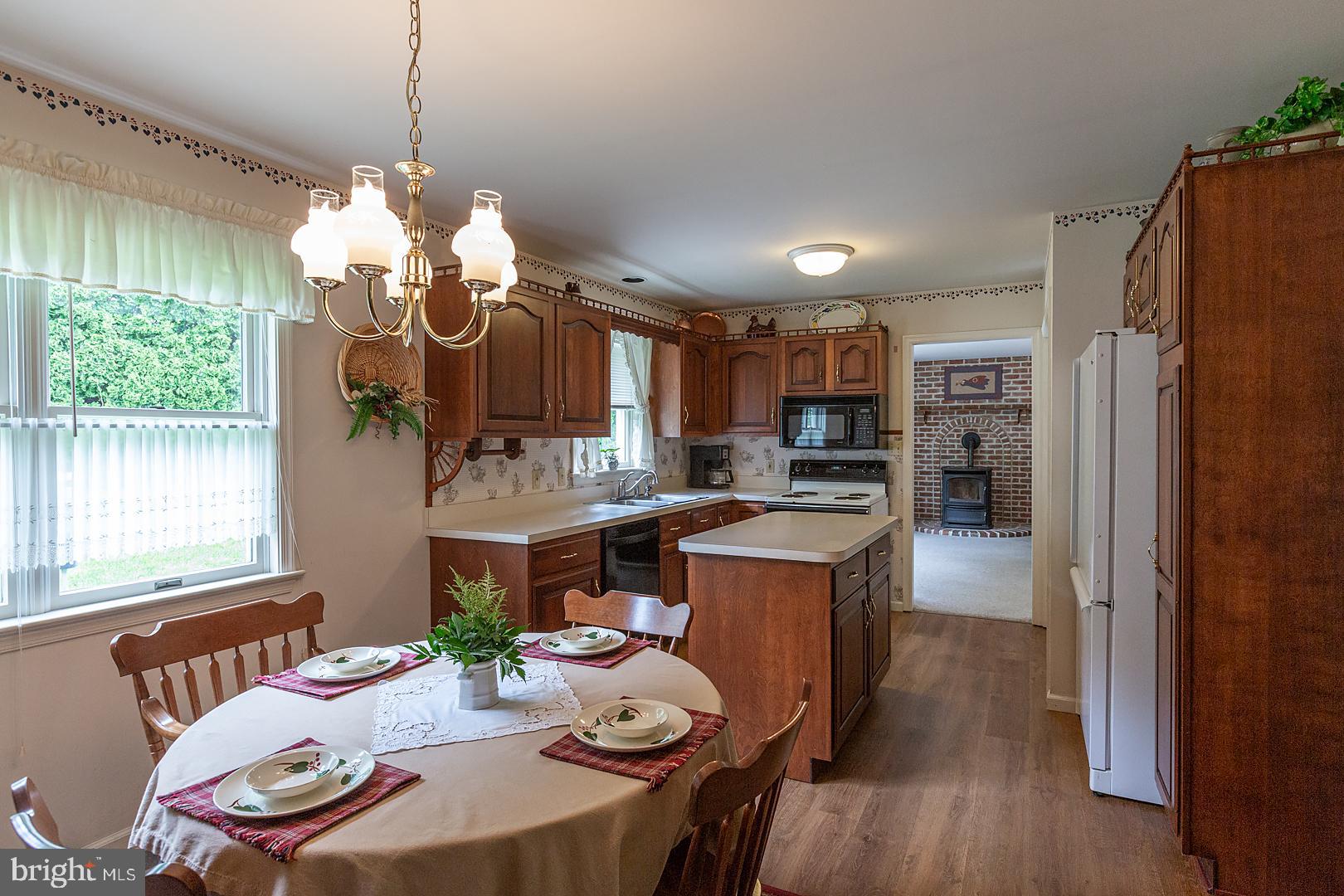 1 Hurst Boulevard Lititz, PA 17543 - Photo 19 of 62 a open kitchen with stainless steel appliances granite countertop a refrigerator a sink dishwasher a dining table and chairs with wooden floor