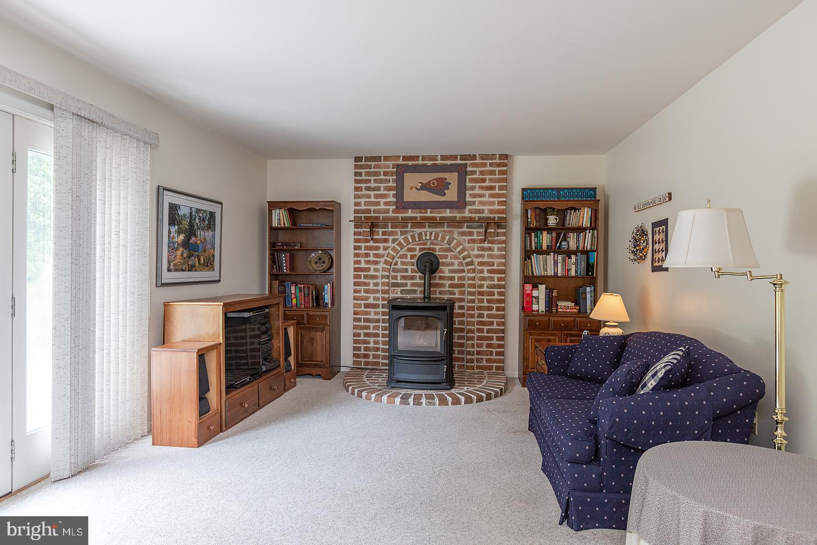 1 Hurst Boulevard Lititz, PA 17543 - Photo 28 of 62 a living room with furniture a flat screen tv and a fireplace