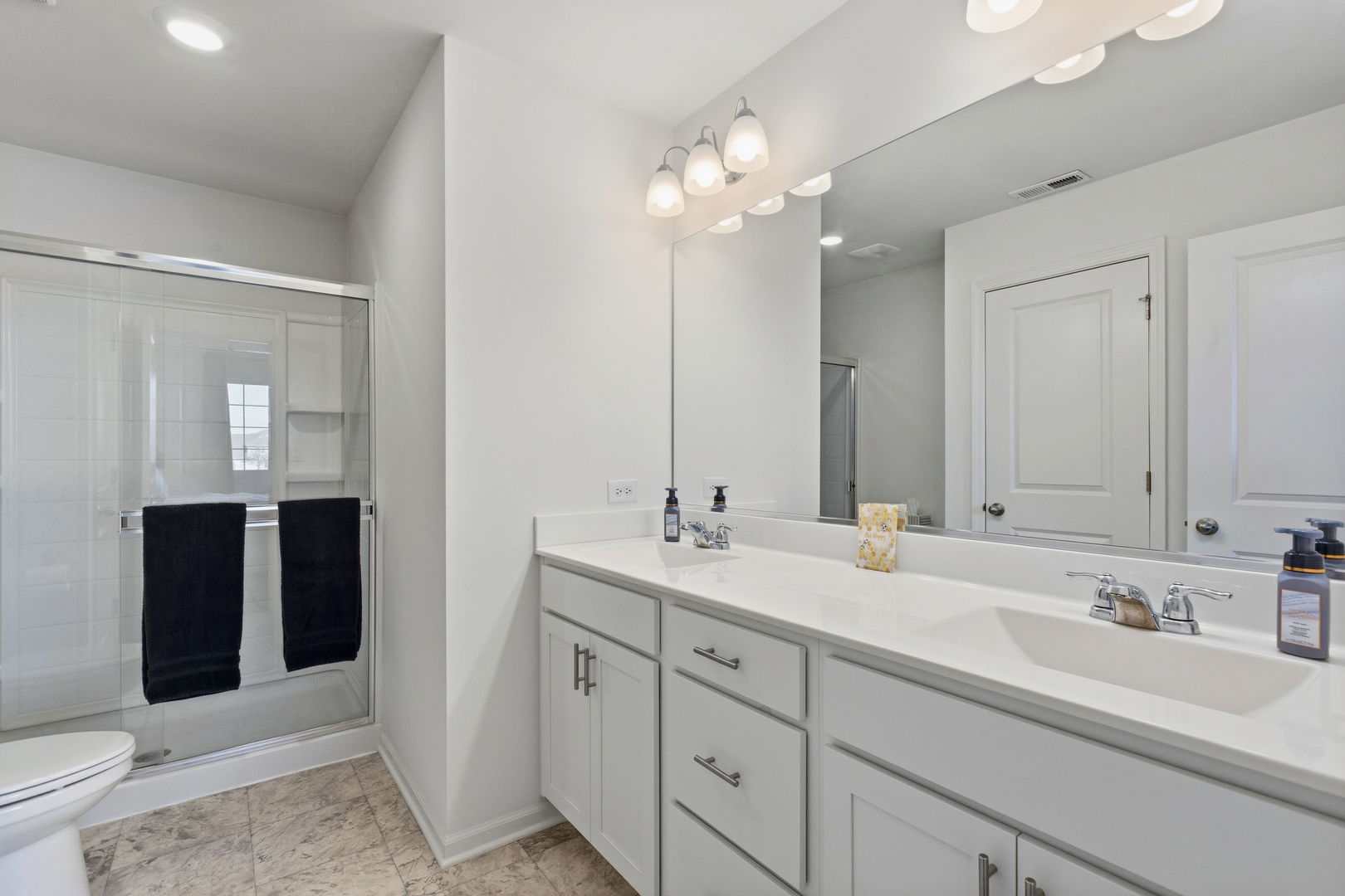 717 Wellington Lane Cary, IL 60013 - Photo 15 of 28 a bathroom with double sink and a mirror