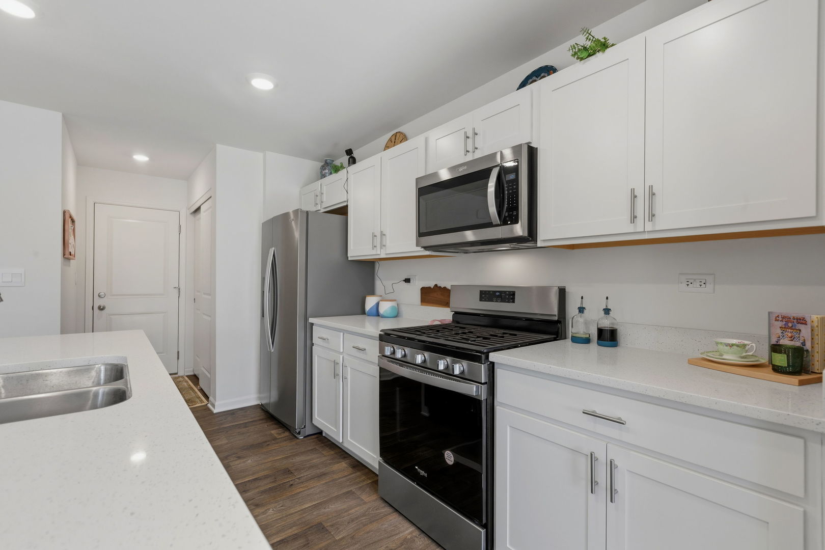 717 Wellington Lane Cary, IL 60013 - Photo 5 of 28 a kitchen with stainless steel appliances granite countertop a refrigerator a stove a sink and white cabinets