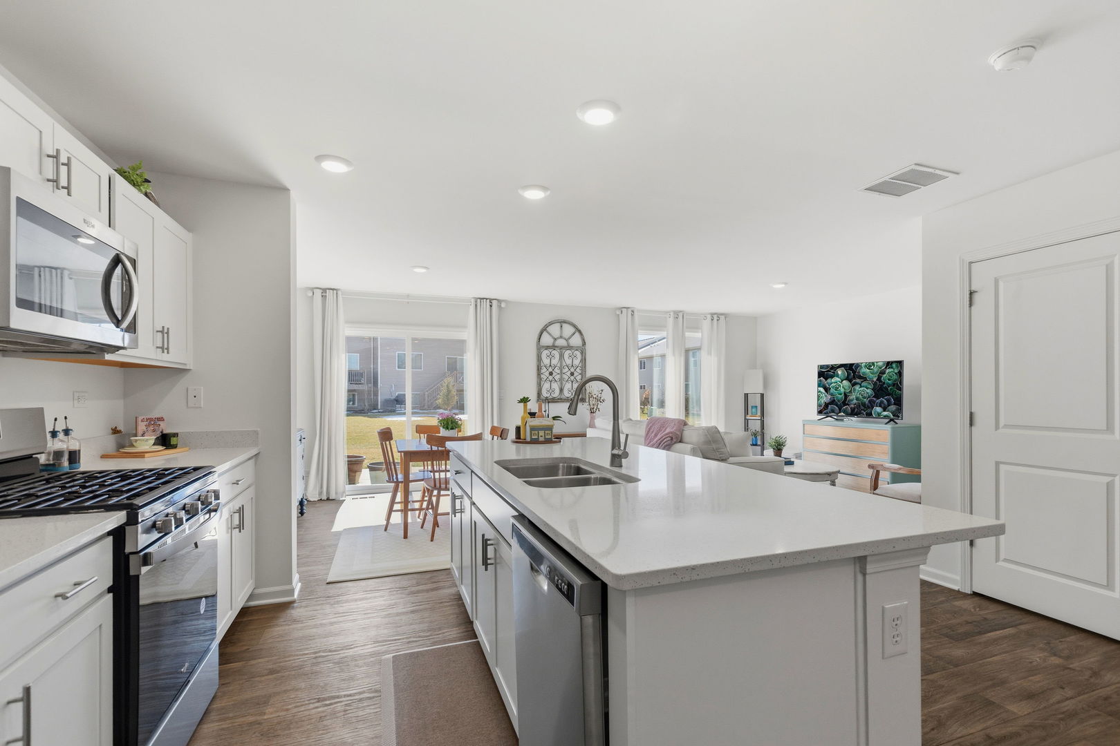 717 Wellington Lane Cary, IL 60013 - Photo 6 of 28 a kitchen with sink stove and cabinets