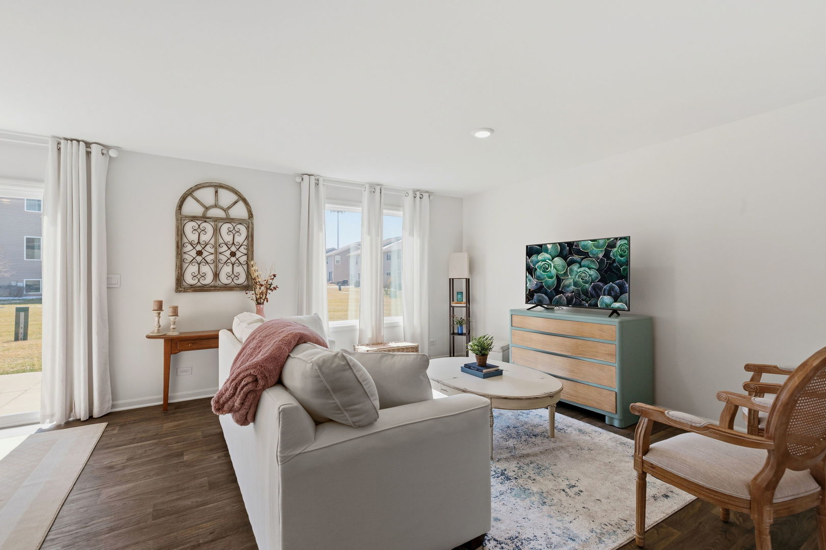 717 Wellington Lane Cary, IL 60013 - Photo 10 of 28 a living room with furniture and a large window