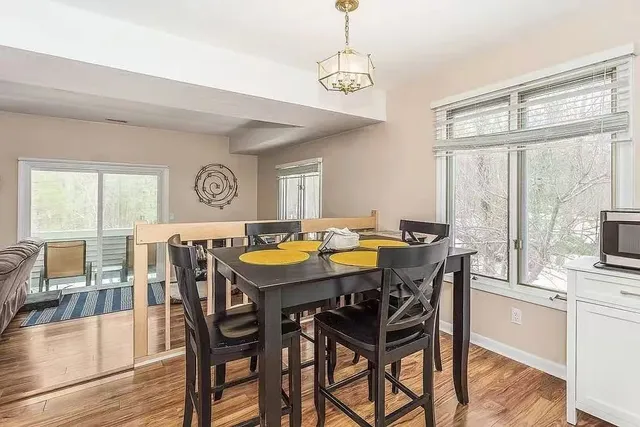 a view of a dining room with furniture window and wooden floor