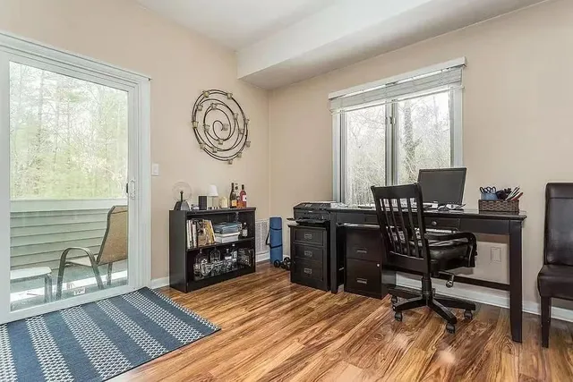a view of a workspace with wooden floor