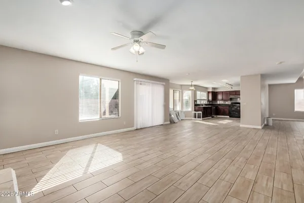 a view of empty room with wooden floor and window