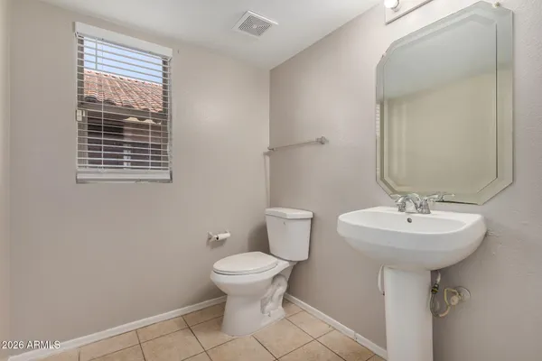 a bathroom with a sink toilet and a mirror