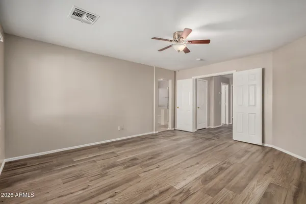 a view of an empty room with wooden floor