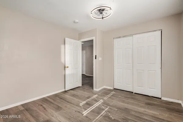 a view of a room with wooden floor and white walls