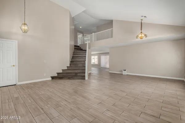 a view of a room with wooden floor and stairs