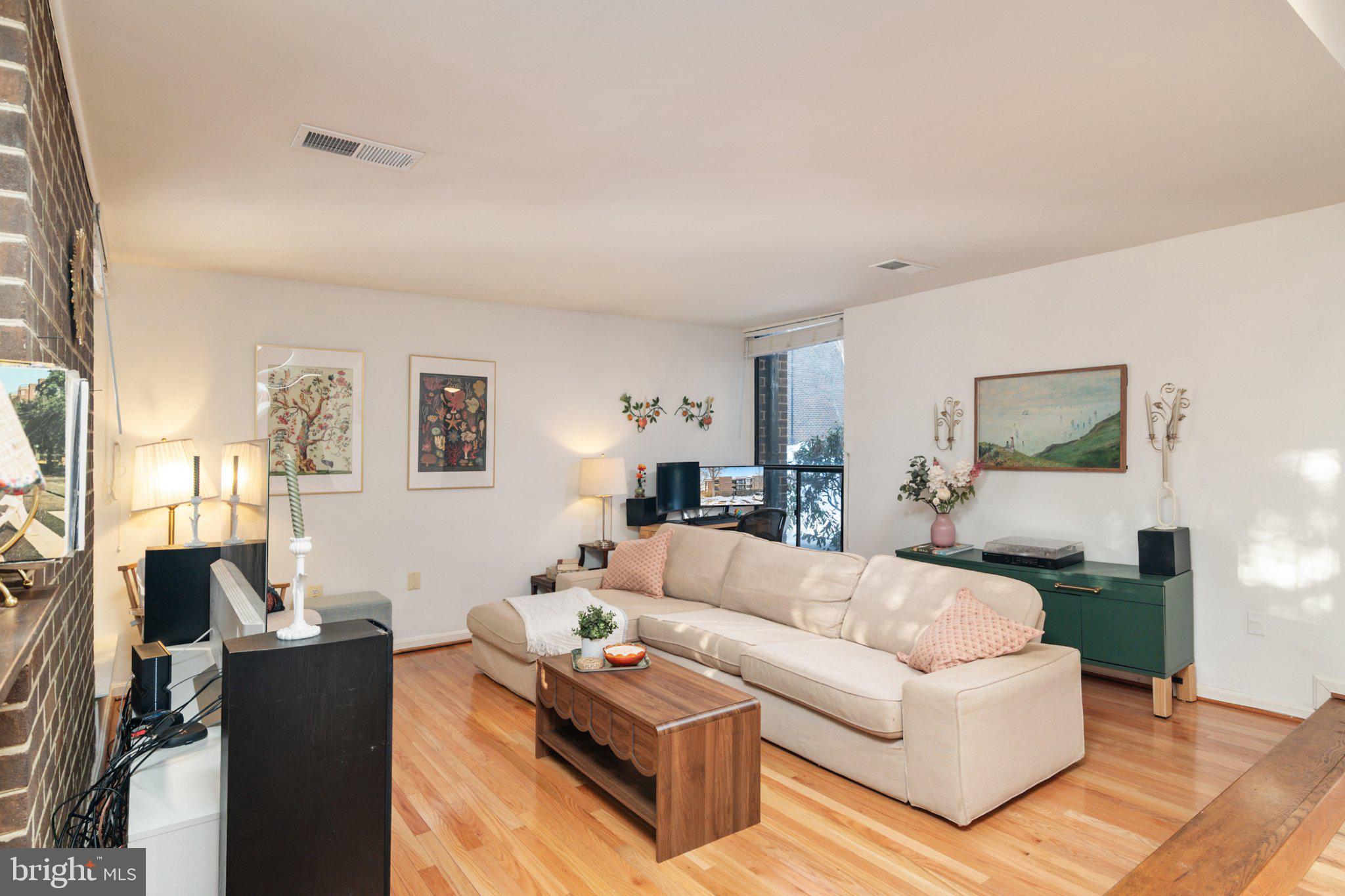 2110 Bonnywood Lane, Unit 3102 Silver Spring, MD 20902 - Photo 3 of 19 a living room with furniture and a wooden floor