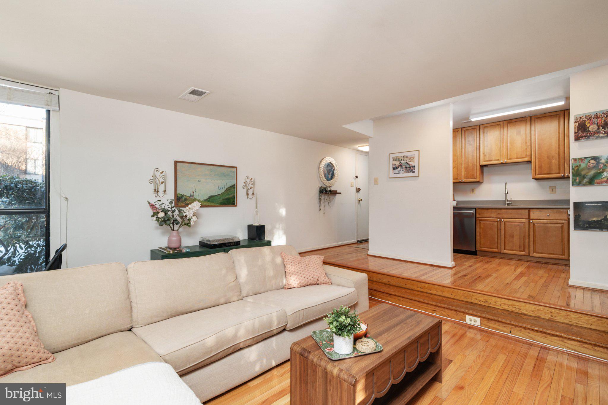 2110 Bonnywood Lane, Unit 3102 Silver Spring, MD 20902 - Photo 6 of 19 a living room with furniture and a large window