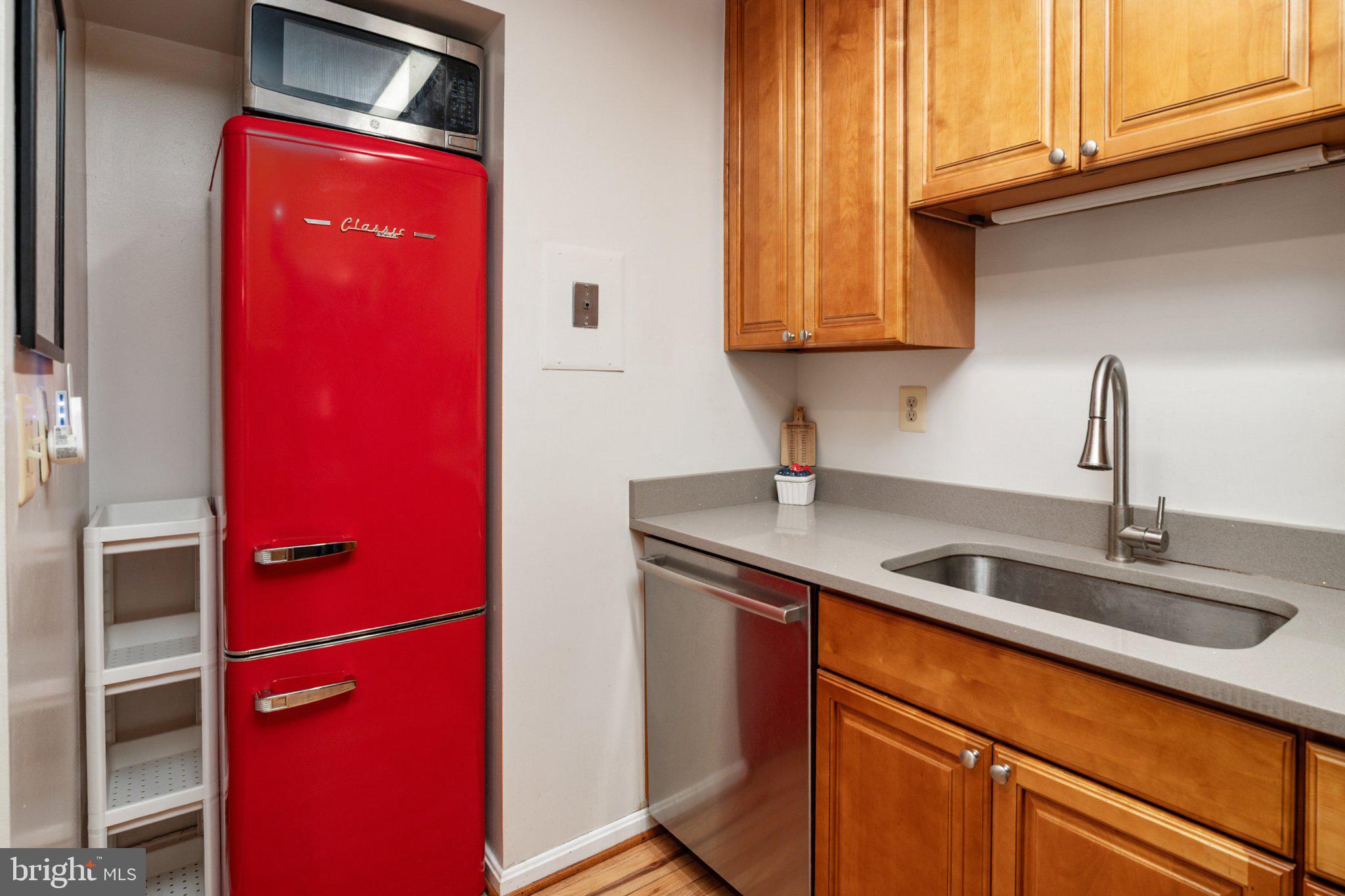 2110 Bonnywood Lane, Unit 3102 Silver Spring, MD 20902 - Photo 8 of 19 a kitchen with stainless steel appliances granite countertop a sink and cabinets