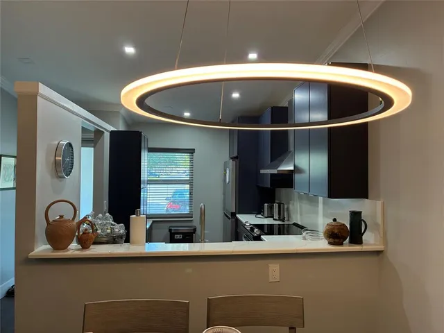 a kitchen with a sink and a stove with wooden floor