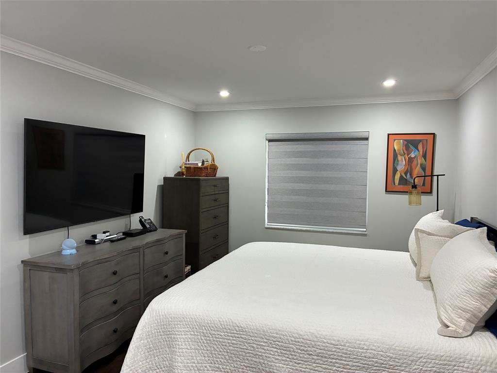 18546 Horizon Avenue, Unit 168 Boca Raton, FL 33496 - Photo 3 of 46 a bedroom with a bed and a flat screen tv