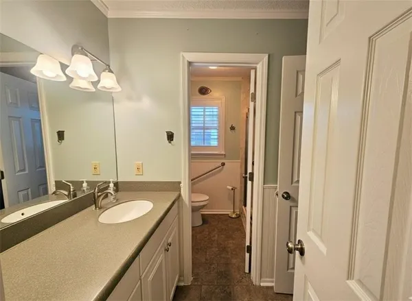a white toilet sitting next to a window