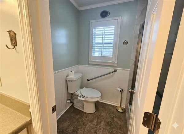 a bathroom with a toilet and a shower
