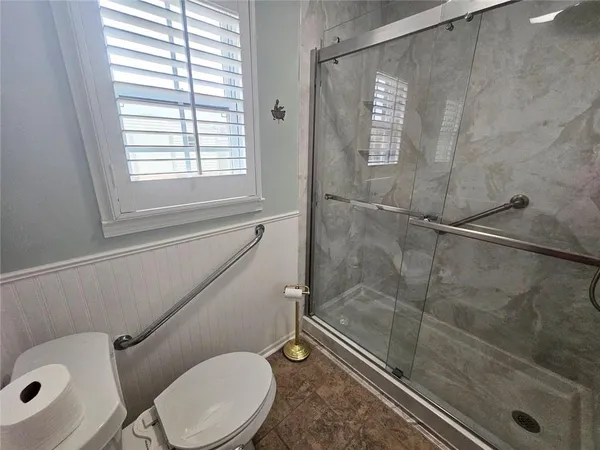 a bathroom with a glass shower door