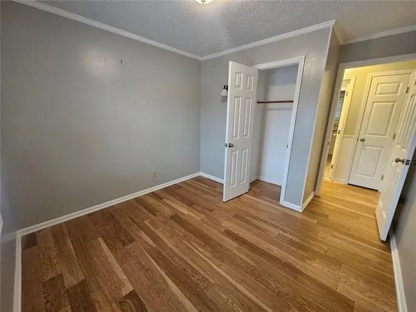 a view of a room with wooden floor and windows