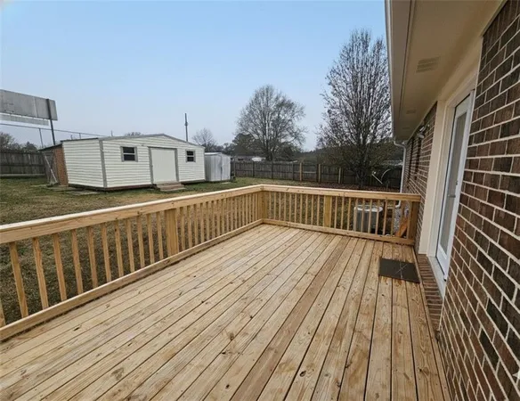 a view of a balcony with wooden floor and fence