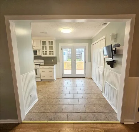 a view of a hallway with a dining room and wooden floor