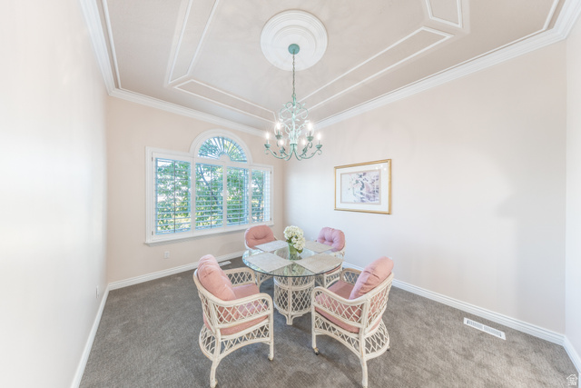 144 Bountiful Boulevard Bountiful, UT 84010 - Photo 15 of 28 Dining area with dark carpet, a chandelier, and crown molding
