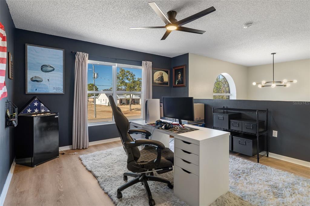 11258 Lomita Wren Road Weeki Wachee, FL 34614 - Photo 35 of 44 a view of a workspace with furniture and a fireplace