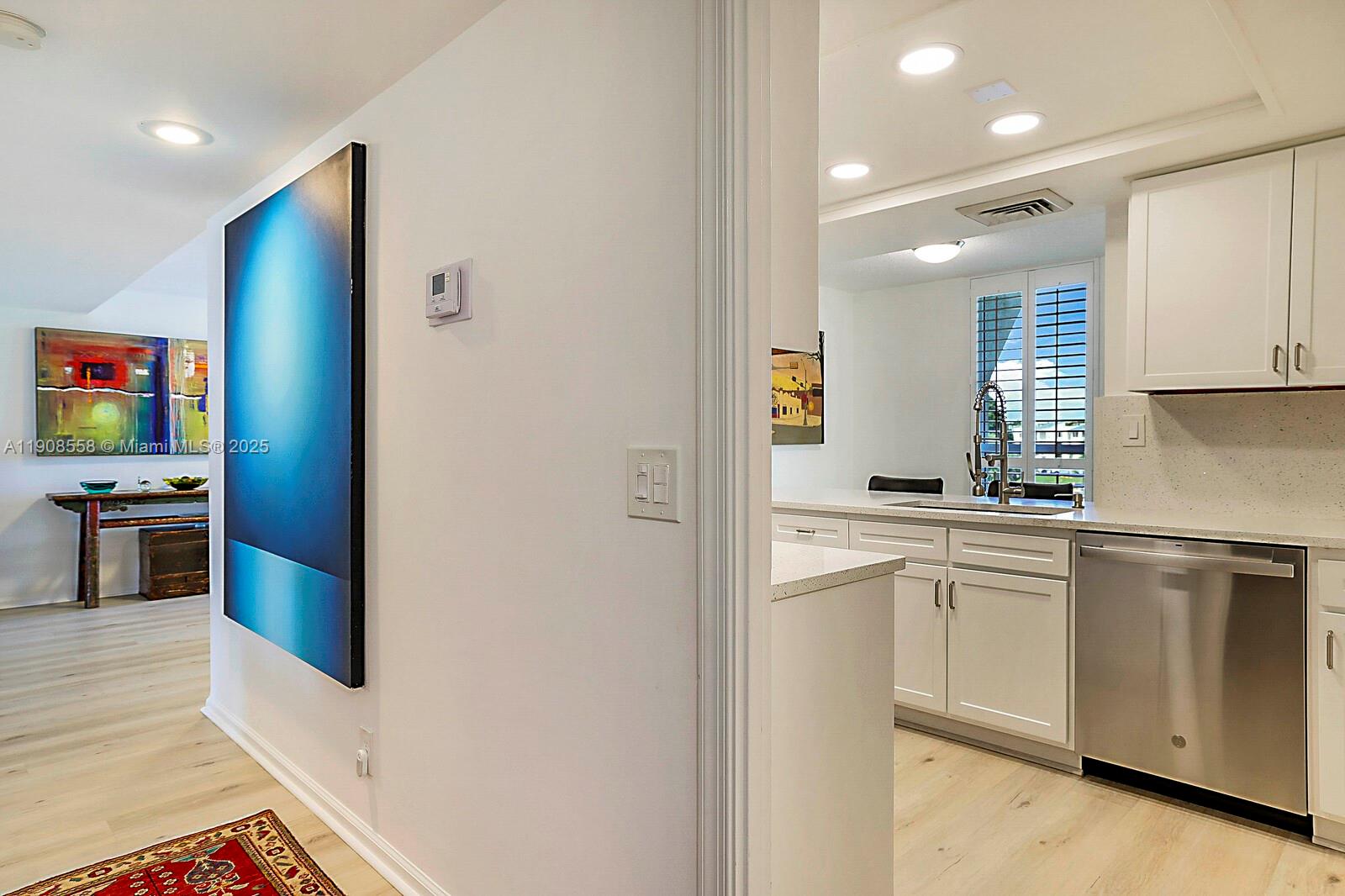 5390 Woodland Lakes Drive, Unit 301 Palm Beach Gardens, FL 33418 - Photo 14 of 34 a kitchen with stainless steel appliances granite countertop a refrigerator and a stove top oven