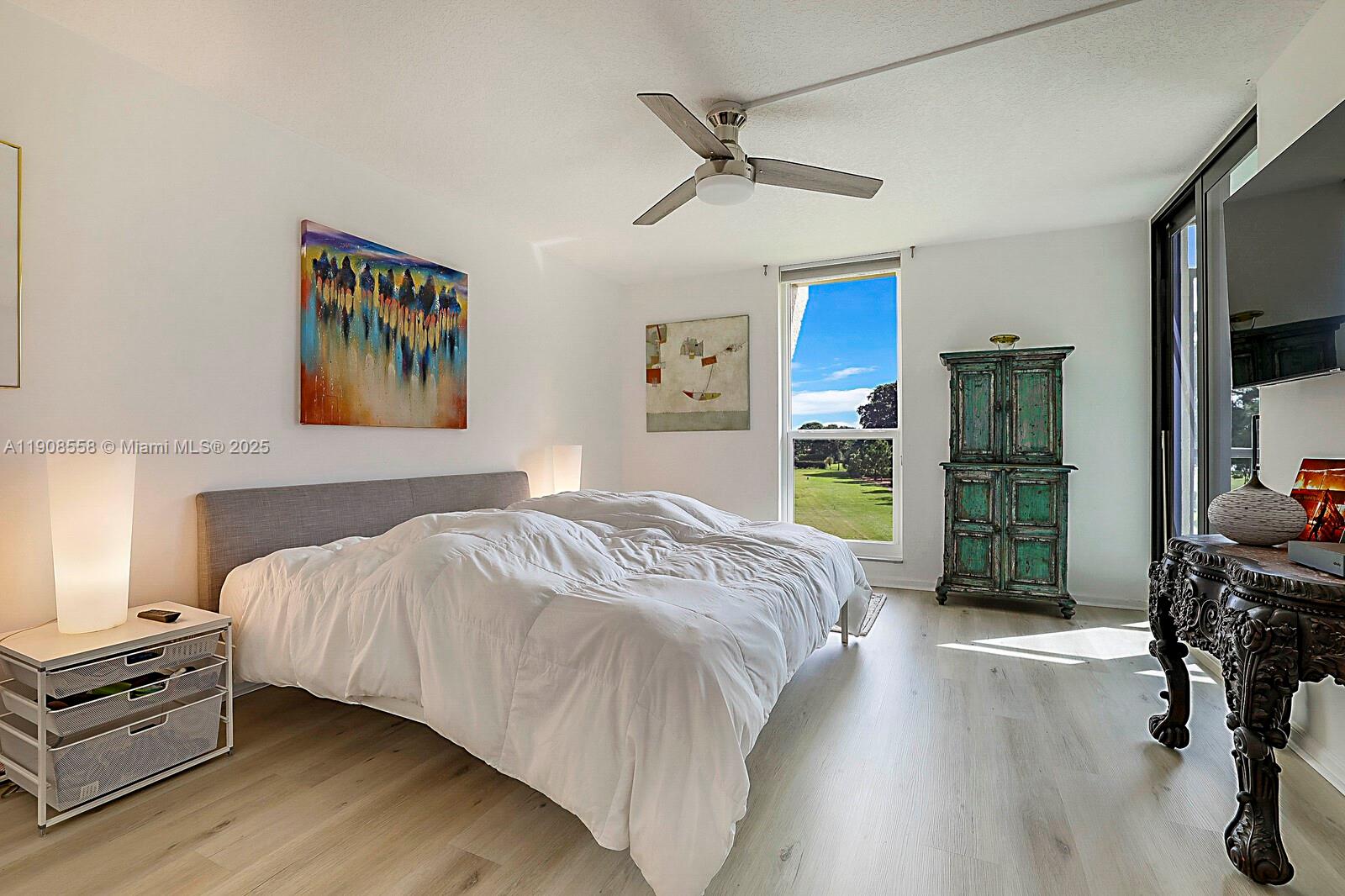 5390 Woodland Lakes Drive, Unit 301 Palm Beach Gardens, FL 33418 - Photo 20 of 34 a bedroom with a bed and a television