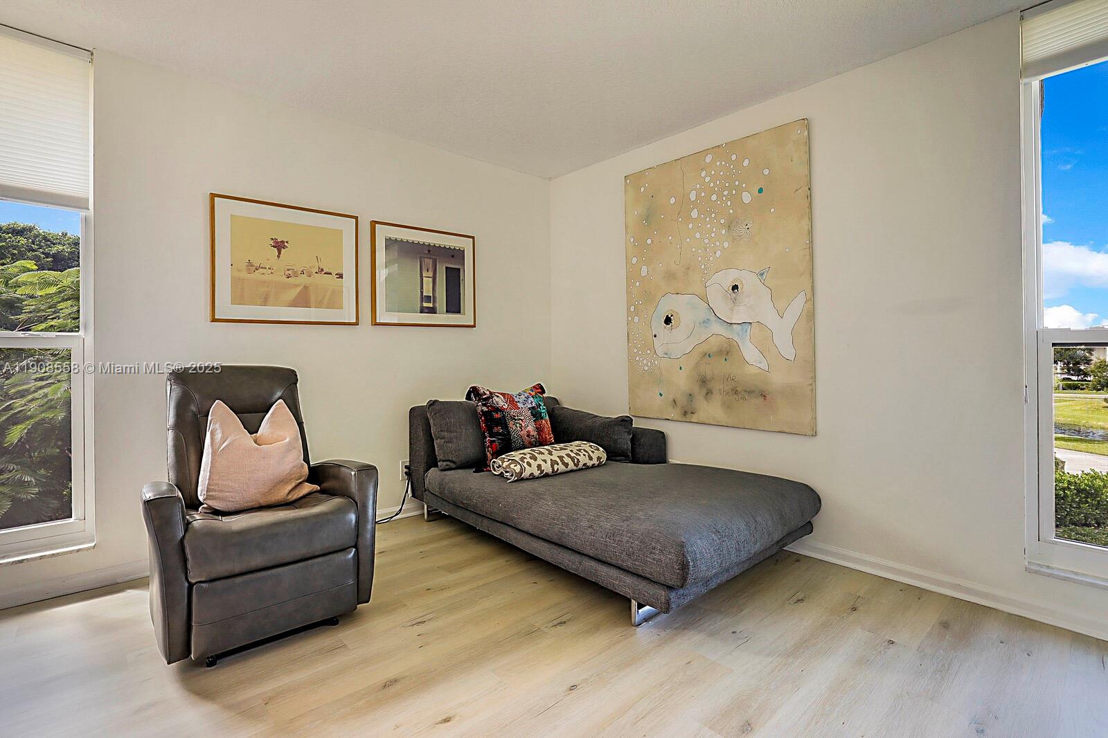 5390 Woodland Lakes Drive, Unit 301 Palm Beach Gardens, FL 33418 - Photo 24 of 34 a living room with furniture and a window