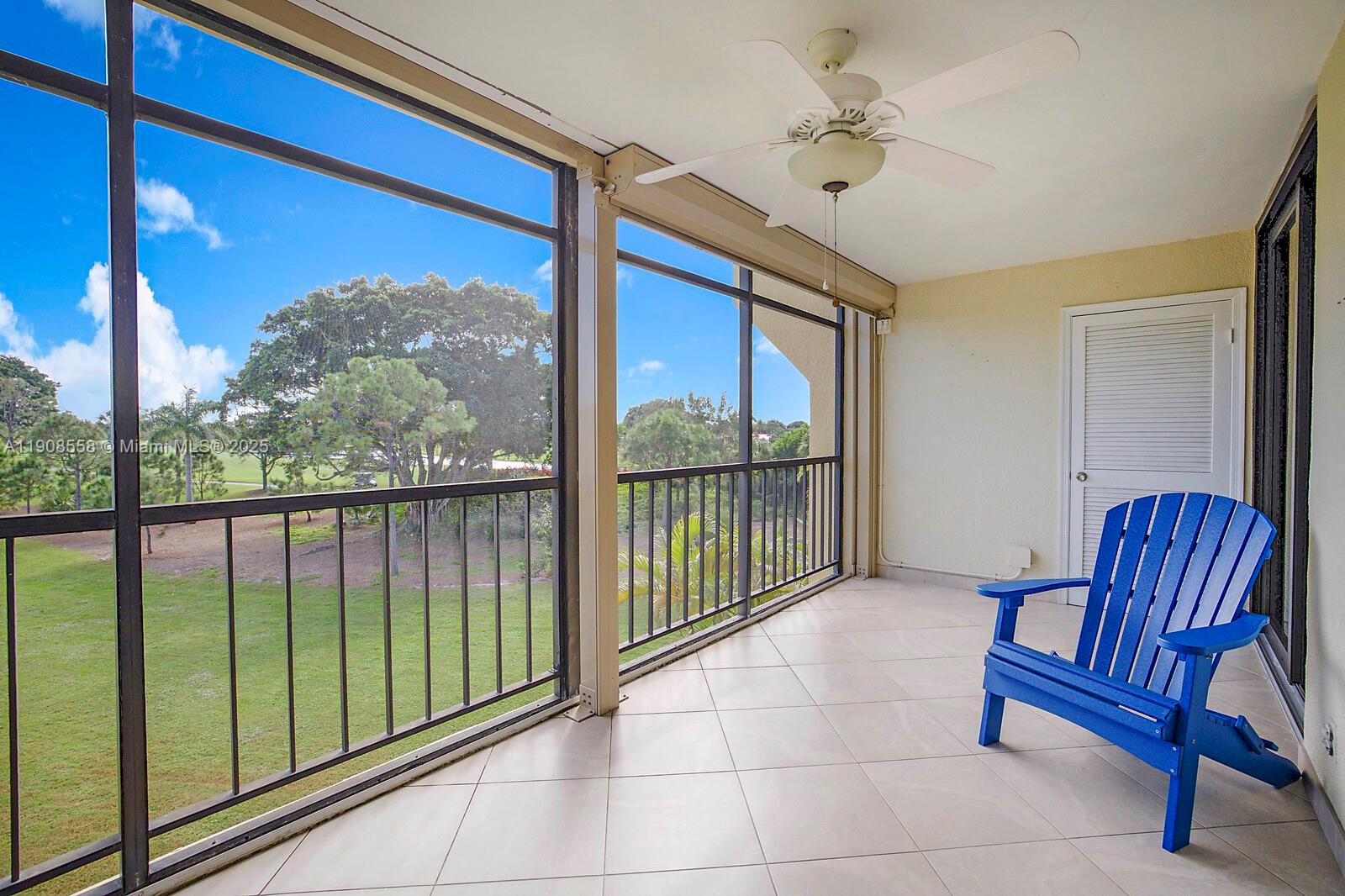 5390 Woodland Lakes Drive, Unit 301 Palm Beach Gardens, FL 33418 - Photo 27 of 34 a view of porch with a chair and floor to ceiling window