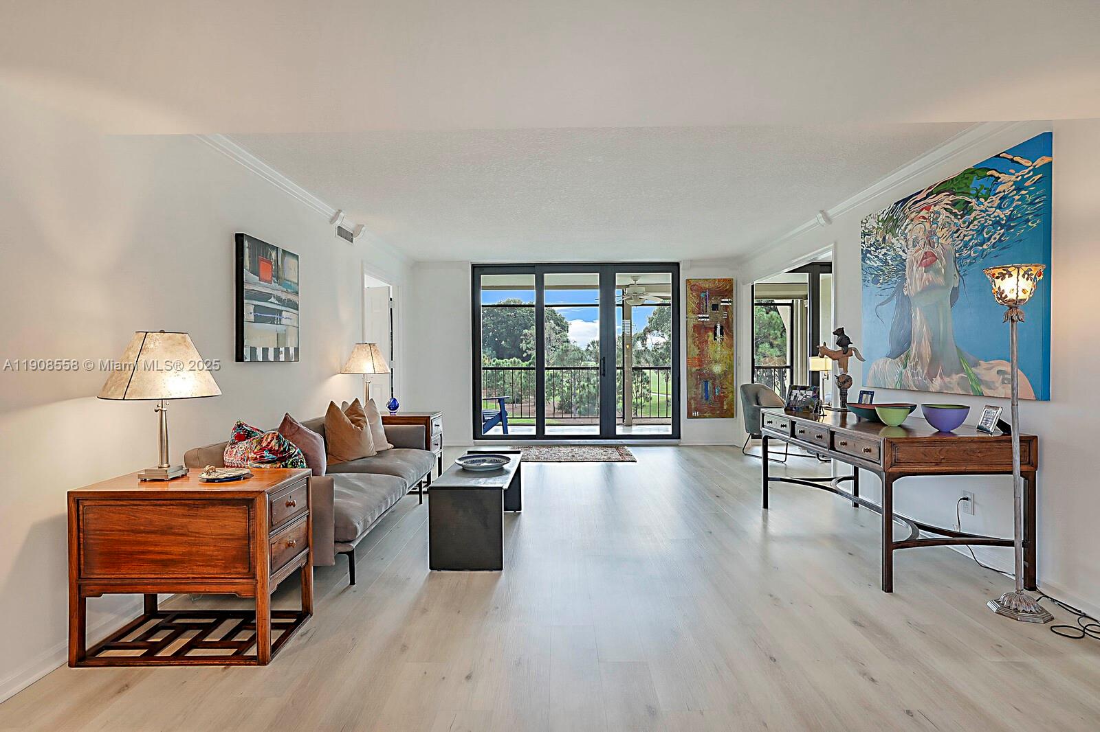 5390 Woodland Lakes Drive, Unit 301 Palm Beach Gardens, FL 33418 - Photo 3 of 34 a living room with furniture and a window