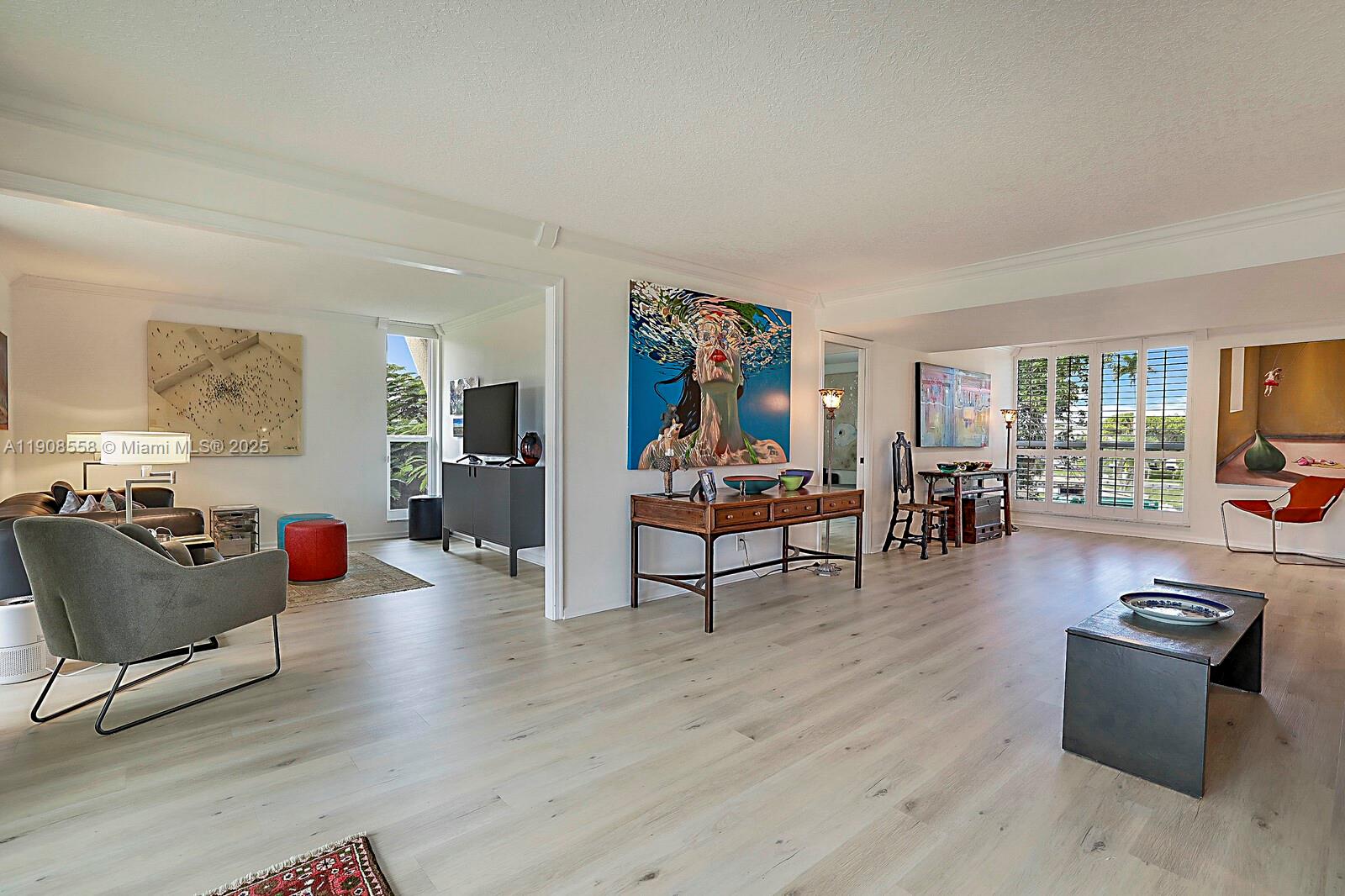 5390 Woodland Lakes Drive, Unit 301 Palm Beach Gardens, FL 33418 - Photo 7 of 34 a living room with furniture and a wooden floor