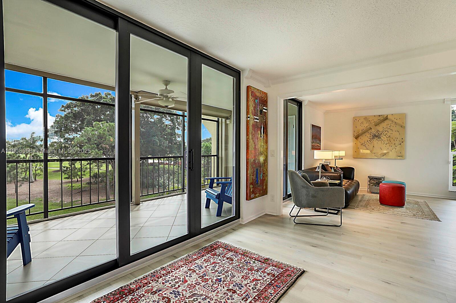 5390 Woodland Lakes Drive, Unit 301 Palm Beach Gardens, FL 33418 - Photo 8 of 34 a living room with furniture and a rug
