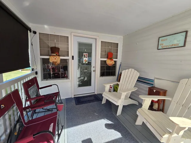 a living room with furniture a flat screen tv and a window