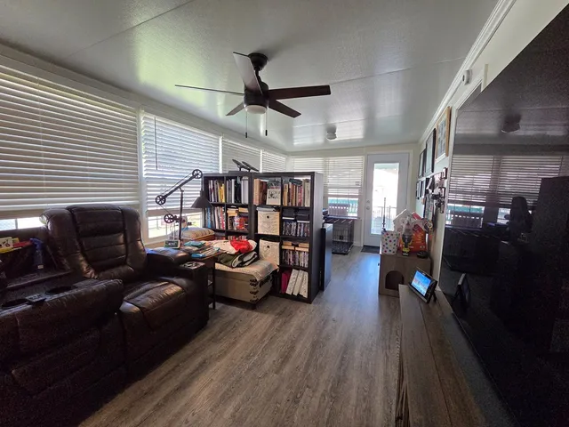 a living room with lots of furniture and wooden floor