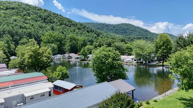 an aerial view of a house with a garden and lake view