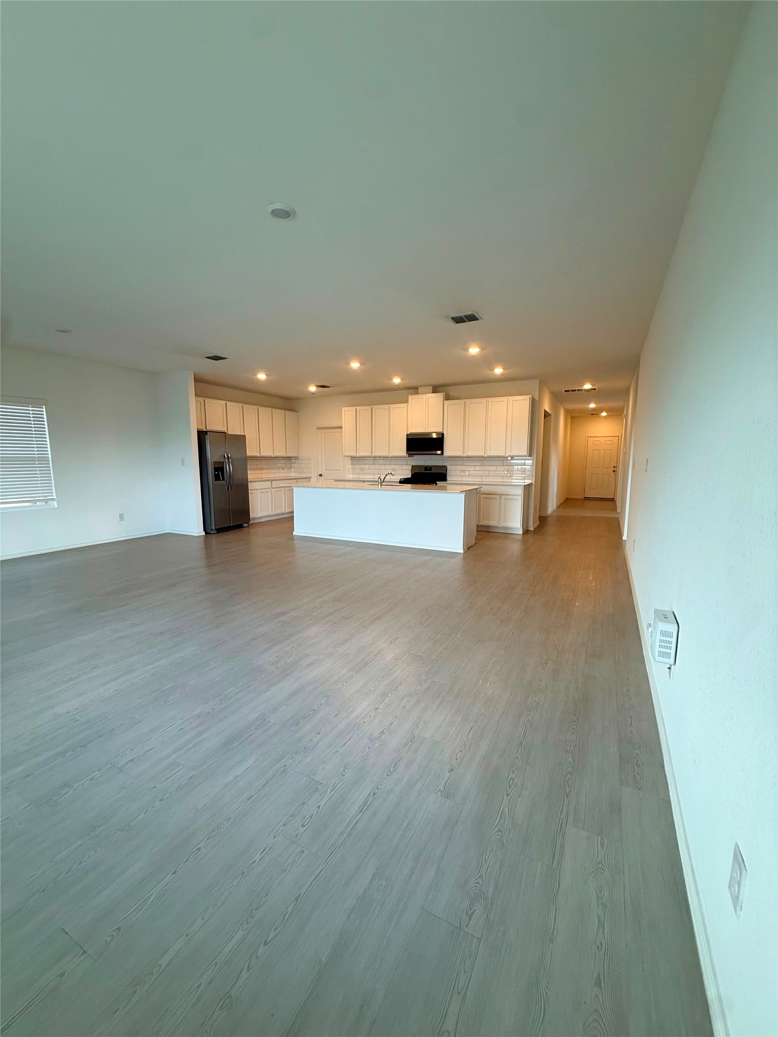 192 Rodney Boat Road Kyle, TX 78640 - Photo 40 of 40 An open floor plan seamlessly connects the well-appointed kitchen with the living area.