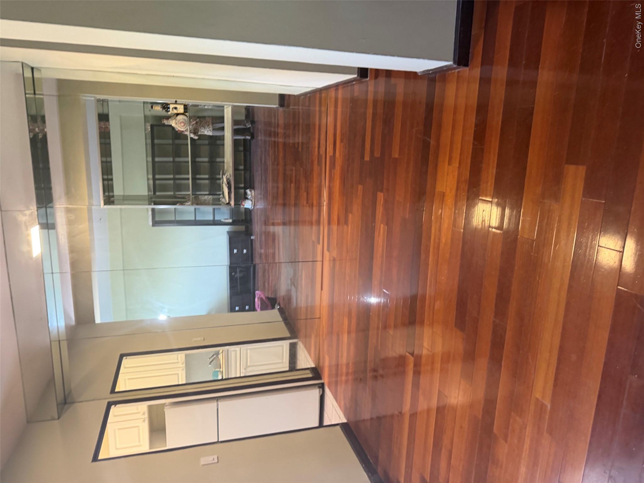 99-32 66th Road, Unit 3AA Queens, NY 11374 - Photo 3 of 9 a view of empty room with wooden floor and fan