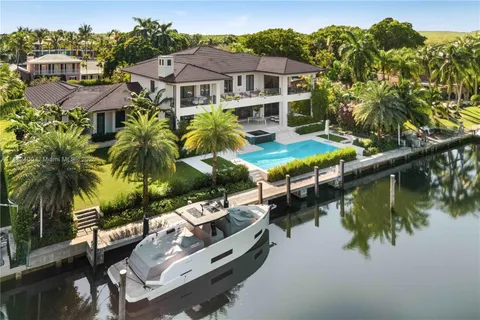 a view of a house with pool and sitting area