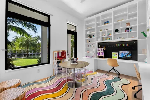 a bathroom with a granite countertop sink and a large mirror