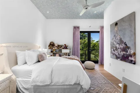 a bedroom with a large bed and a chandelier