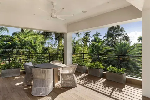 a view of a house with backyard porch and sitting area