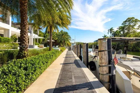 a view of a house with pool and sitting area