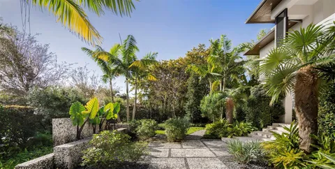 a front view of a residential houses with yard
