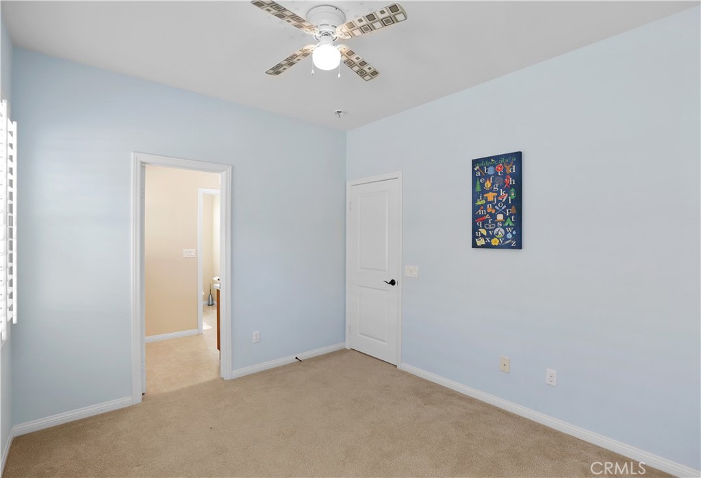 64 Prickly Pear Irvine, CA 92618 - Photo 22 of 35 an empty room with a chandelier fan and windows