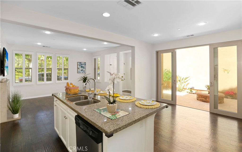 64 Prickly Pear Irvine, CA 92618 - Photo 8 of 35 a kitchen with granite countertop a sink a counter top space and living room view