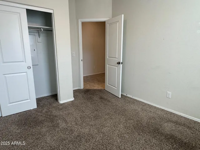 an empty room with closet area
