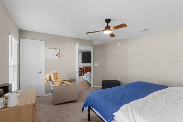 a bedroom with a bed and a couch